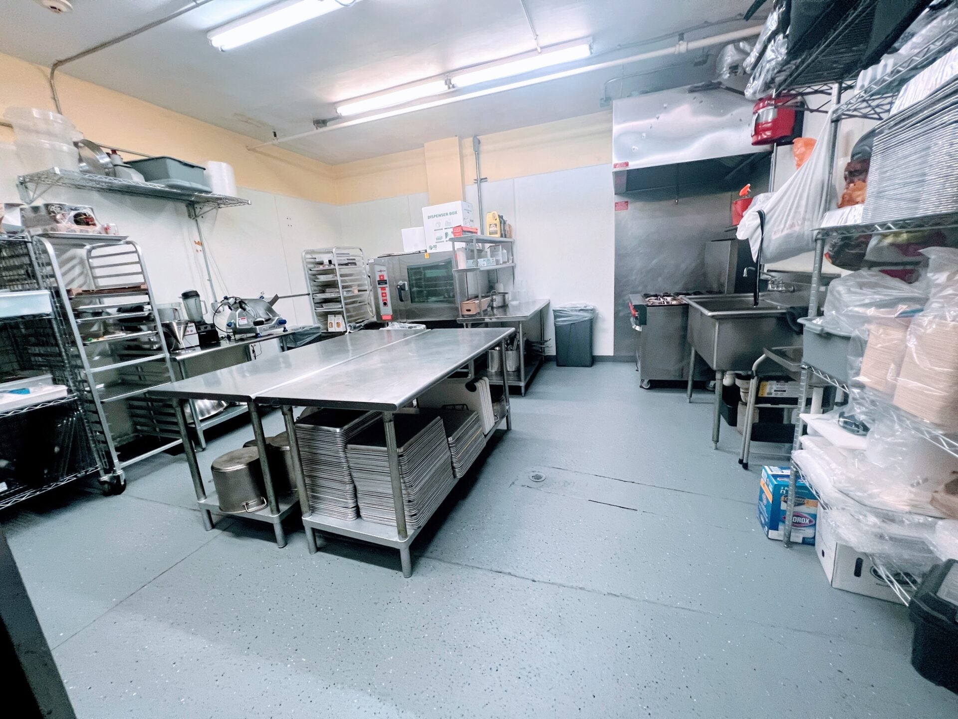 May Your Whisk Come True kitchen with stainless prep tables, racks, and convection ovens in Englewood, NJ.